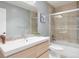 Modern bathroom featuring a spacious vanity, large mirror, and a sleek glass-enclosed shower at 223 Castlemaine Ct, Castle Rock, CO 80104