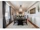 Formal dining room featuring a long table, chandelier, and large windows at 223 Castlemaine Ct, Castle Rock, CO 80104