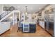 Modern kitchen featuring an island with seating, stainless steel appliances, and hardwood floors at 223 Castlemaine Ct, Castle Rock, CO 80104