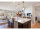 Open kitchen featuring a large island with sink and views of the breakfast nook and Gathering room at 223 Castlemaine Ct, Castle Rock, CO 80104