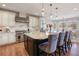Spacious kitchen featuring a large island, pendant lights, and stainless steel appliances at 223 Castlemaine Ct, Castle Rock, CO 80104