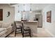 Cozy kitchenette with bar seating, stainless steel appliances, and stylish pendant lighting at 223 Castlemaine Ct, Castle Rock, CO 80104