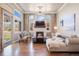 Bright living room features a fireplace, hardwood floors, and large windows with scenic views at 223 Castlemaine Ct, Castle Rock, CO 80104