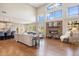 Inviting living room with hardwood floors, fireplace, vaulted ceilings, and large windows at 223 Castlemaine Ct, Castle Rock, CO 80104