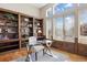 Office with built-in bookshelves, hardwood floors, and large windows for natural light at 223 Castlemaine Ct, Castle Rock, CO 80104