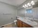 Bathroom featuring double sink vanity with a large mirror, and updated lighting fixtures at 342 Olympia Ave, Longmont, CO 80504