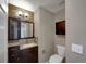 Cozy half bath with dark wood cabinets, granite counters, decorative backsplash, and a modern vanity at 342 Olympia Ave, Longmont, CO 80504