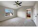 Bright bedroom featuring large windows and modern ceiling fan and access to en-suite bathroom at 342 Olympia Ave, Longmont, CO 80504