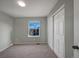 Cozy bedroom with neutral carpeting, a large window, and a spacious closet with sliding doors at 342 Olympia Ave, Longmont, CO 80504