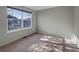 Well-lit bedroom with neutral walls, plush carpeting, and a large window providing ample natural light at 342 Olympia Ave, Longmont, CO 80504