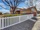Charming home with a white picket fence and lush landscaping, providing a welcoming curb appeal at 342 Olympia Ave, Longmont, CO 80504