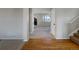 Inviting foyer leading to the living area, showcasing hardwood floors and a staircase at 342 Olympia Ave, Longmont, CO 80504