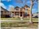 Charming two-story home featuring a welcoming front porch and a well-maintained lawn on a sunny day at 342 Olympia Ave, Longmont, CO 80504