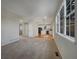 Open-concept space with carpeted living area leading to a kitchen with stainless appliances and white cabinets at 342 Olympia Ave, Longmont, CO 80504