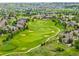 An aerial view features a lush green golf course and beautiful homes in this wonderful community at 8267 S Sicily Ct, Aurora, CO 80016