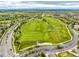 This aerial view shows a golf course and neighborhood with well-maintained landscaping in a suburban community at 8267 S Sicily Ct, Aurora, CO 80016