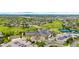An aerial view of a neighborhood with houses, a parking lot, a golf course and a tennis court at 8267 S Sicily Ct, Aurora, CO 80016