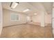 Finished basement area with tile flooring, bright lighting, and convenient window access at 8267 S Sicily Ct, Aurora, CO 80016