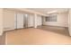 Spacious basement with tile flooring, multiple storage closets, and ample lighting at 8267 S Sicily Ct, Aurora, CO 80016