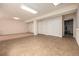 Basement area with tile flooring, ample lighting, storage, and mechanical access at 8267 S Sicily Ct, Aurora, CO 80016