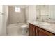 Well-lit bathroom featuring tiled walls, a bathtub, and a vanity with ample counter space at 8267 S Sicily Ct, Aurora, CO 80016