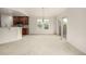 Bright dining area featuring a modern chandelier, sliding glass doors, and adjacent kitchen access at 8267 S Sicily Ct, Aurora, CO 80016