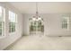 Sun-filled dining space with sliding glass doors and picturesque views, complemented by a modern chandelier at 8267 S Sicily Ct, Aurora, CO 80016