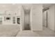 Open entryway view of living area with fireplace and access to tiled hallway at 8267 S Sicily Ct, Aurora, CO 80016
