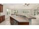Bright open kitchen featuring a breakfast bar with a double sink, stainless steel dishwasher, and natural light at 8267 S Sicily Ct, Aurora, CO 80016