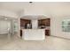 Open kitchen and living area featuring a breakfast bar, stainless steel appliances, and neutral decor at 8267 S Sicily Ct, Aurora, CO 80016