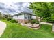 Beautifully landscaped yard with brick-lined garden beds, lush green lawn, and charming home exterior at 8267 S Sicily Ct, Aurora, CO 80016
