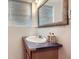 Bathroom featuring a wood vanity with a sink and a decorative mirror at 18891 E Carmel Dr, Aurora, CO 80011