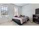 Bedroom featuring two windows, a bed, and a dark brown shelf at 18891 E Carmel Dr, Aurora, CO 80011