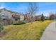 Well-maintained townhome with lawn and mature trees near a sidewalk at 3090 W 107Th Pl # F, Westminster, CO 80031