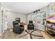 Bright living room offering comfortable seating and a view of the neighborhood through a large window at 3090 W 107Th Pl # F, Westminster, CO 80031