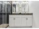 Modern bathroom featuring double vanity with gold fixtures and a glass-enclosed shower at 717 Inca St, Denver, CO 80204