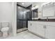 Stylish bathroom with double vanity, modern fixtures, and glass shower with dark tile at 717 Inca St, Denver, CO 80204