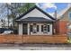 Front exterior featuring a black and white color scheme, wood fence, and tidy landscaping at 717 Inca St, Denver, CO 80204