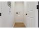 Neutral hallway featuring white walls, light wood floors, and a modern door at 717 Inca St, Denver, CO 80204
