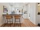 Modern kitchen featuring stainless steel appliances, light cabinets and an island with bar stool seating at 717 Inca St, Denver, CO 80204