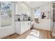 Bright kitchen featuring white cabinets, stainless steel appliances, and natural light at 717 Inca St, Denver, CO 80204