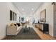 Bright living room featuring modern decor, hardwood floors and an open floor plan flowing into the kitchen at 717 Inca St, Denver, CO 80204