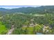Aerial view of the home nestled in a serene wooded area at 4724 Hopi Rd, Indian Hills, CO 80454