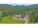 Aerial view of the home nestled in a serene wooded area at 4724 Hopi Rd, Indian Hills, CO 80454