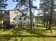 Inviting backyard space featuring lush greenery, mature trees, and outdoor recreational elements at 4724 Hopi Rd, Indian Hills, CO 80454