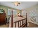 Cozy bedroom with a four-poster bed, dresser, and view to the yard through the window at 4724 Hopi Rd, Indian Hills, CO 80454