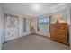 Bedroom featuring wood dresser, two windows, and a door to the exterior at 4724 Hopi Rd, Indian Hills, CO 80454