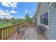 Charming deck featuring outdoor furniture, decorative rug, and scenic views of the surrounding greenery at 4724 Hopi Rd, Indian Hills, CO 80454