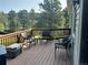 Relaxing deck with seating and lovely green trees as a backdrop at 4724 Hopi Rd, Indian Hills, CO 80454