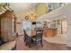 View of dining area and kitchen with wood and tile flooring at 4724 Hopi Rd, Indian Hills, CO 80454